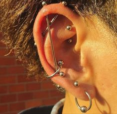 a person with some piercings on their ear