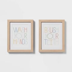 two framed art pieces with the words wash your hands and brush your teeth on them