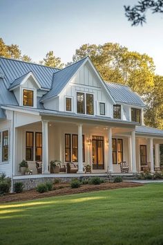 a large white house sitting on top of a lush green field