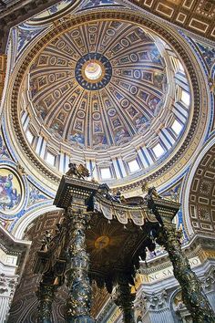 an ornate ceiling in the center of a building