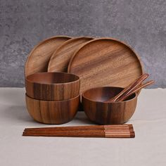 a wooden dinner set with chopsticks and bowls