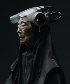 an old man wearing a black robe and headphones