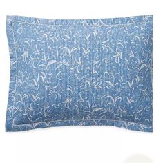 a blue and white pillow on a white background