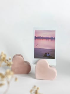 two heart shaped soaps sitting next to each other on top of a white table