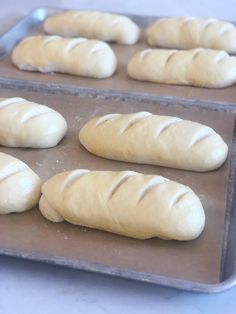 several loaves of bread sitting on top of a pan