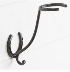 an iron hook on the side of a white wall