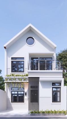 a white two story house with windows and balconies on the second floor is shown