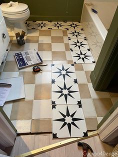 a bathroom floor that has been painted with black and white tiles