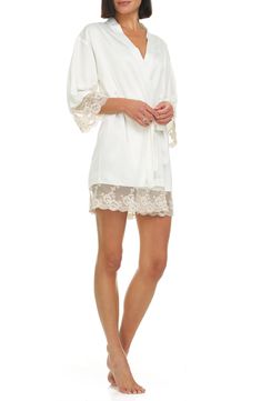 A lustrous satin robe edged with sheer floral lace is sure to make your mornings and evenings a little bit sweeter. 35 1/2" length (size Medium) Shawl collar Three-quarter sleeves Removable tie belt 100% polyester Hand wash, dry flat Imported Spring Silk Sleepwear With Lace Trim, White Lace Trim Robe For Wedding Night, White Robe With Lace Trim For Wedding Night, Fitted Robe With Lace Sleeves For Wedding Night, Fitted Wedding Night Robe With Lace Sleeves, Elegant Spring Sleepwear With Lace Trim, Elegant Summer Lace Robe, White Lace Robe With Lace Trim, Fitted Lace Robe With Sheer Details