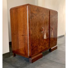 a wooden cabinet sitting on top of a cement floor