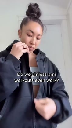 a woman in a black jacket is looking at her cell phone and has the words do weightless arm workouts even work?