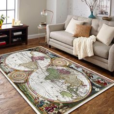 a living room filled with furniture and a large rug on top of a hard wood floor