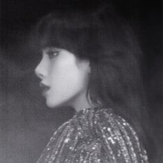 a black and white photo of a woman with long hair looking off to the side