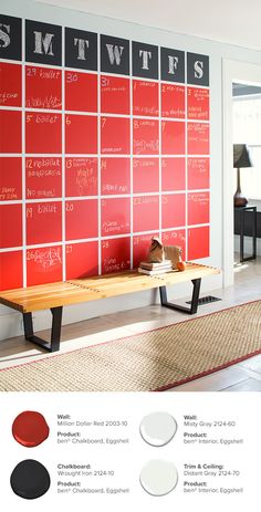 a red and black wall mounted to the side of a wooden bench with writing on it