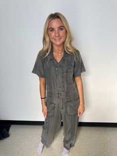 A classic utility-style jumpsuit in an ash grey wash tencel. Tencel Relaxed fit Short sleeve Long straight leg Collared neckline Button front top Zip fly closure Front patch pockets Back patch pocket Utility jumpsuit A jumpsuit to wear on repeat all spring and summer long. Featuring the perfect relaxed fit, our utility-style one-piece is crafted from lightweight tencel and features a button-front top and collared neckline. Short sleeves keep things breezy, while the straight long leg pairs well Casual Gray Jumpsuits And Rompers For Work, Utility Denim Jumpsuit With Short Sleeves And Pockets, Utility Denim Jumpsuit With Pockets And Short Sleeves, Utility Short Sleeve Denim Jumpsuit With Pockets, Casual Short Sleeve Jumpsuits And Rompers With Buttoned Pockets, Casual Overalls With Button Closure, Casual Short Sleeve Overalls With Button Closure, Casual Overalls With Button Closure And Short Sleeves, Casual Workwear Denim Jumpsuit With Side Pockets