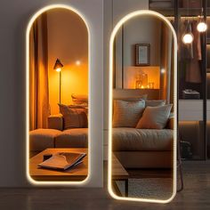 two mirrors that have lights on them near a couch