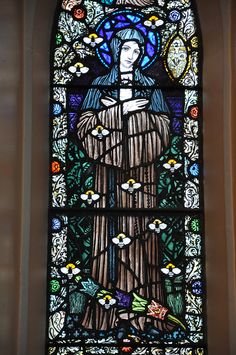 a stained glass window with a woman in it