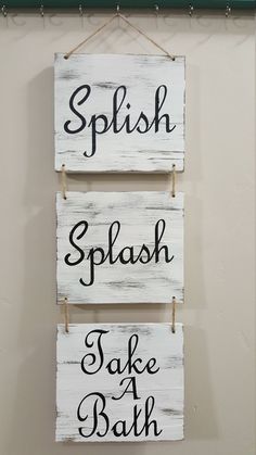 two wooden signs hanging on the wall with words above them that read splish splash take a bath