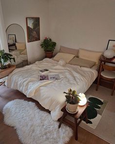 a large bed sitting in the middle of a living room