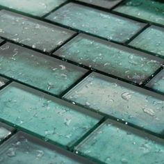 green glass tile with water drops on it