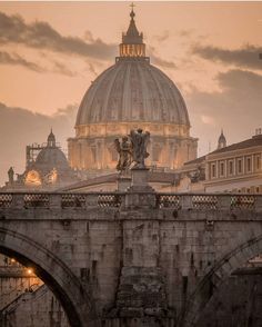 the dome of st peter's cathedral is seen from across the river in rome