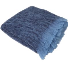 a blue blanket with fringes on it is laying in front of a white background