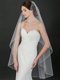 a woman in a wedding dress wearing a veil