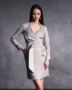 Embrace timeless elegance with this Light Grey Satin Long Sleeve Wrap Dress, a show-stopping piece designed for women who love to make a statement. Made from luxurious satin fabric and featuring a dazzling rhinestone buckle belt, this mini dress is ideal for cocktail parties, formal evenings, and special occasions. Its sleek, flattering design ensures you'll turn heads wherever you go. ❤️🔥 🌟 Unique Features: ✨Sleek Satin Fabric: The smooth, lustrous satin gives this dress a touch of luxury that's perfect for evening wear. ✨Glamorous Rhinestone Buckle: The rhinestone belt cinches the waist, creating a flattering hourglass silhouette and adding a sparkling detail that catches the light beautifully. ✨Long Sleeves with Wrap Front: Designed to elongate the arms and offer a sophisticated, tail Satin Wrap Dress, Hourglass Silhouette, Long Sleeve Wrap Dress, Satin Long Sleeve, Rhinestone Belt, Cocktail Parties, Mini Dresses For Women, Unique Features, Buckle Belt