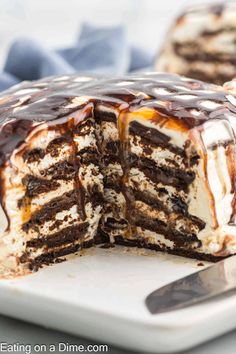 a chocolate cake with white frosting and caramel drizzled on top