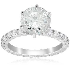 a white gold engagement ring with an oval cut diamond in the center and side stones