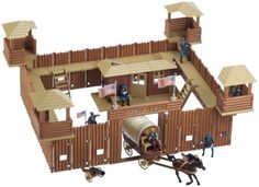 a wooden model of a building with horses pulling it and people standing on the roof