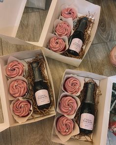 three boxes filled with cupcakes and wine bottles on top of a wooden table