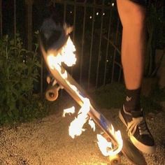 a person on a skateboard with flames coming out of the bottom part of it