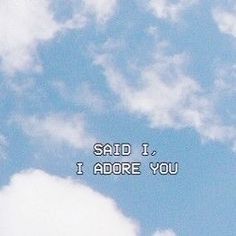 the words said i adore you are written in white on a blue sky with clouds