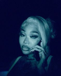 a woman talking on a cell phone in the dark