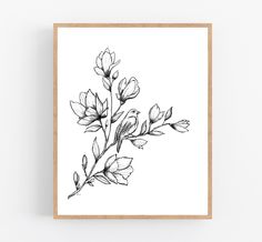 a black and white drawing of some flowers on a white background framed in a wooden frame