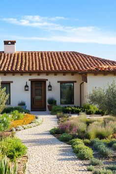 a white house with a brown door surrounded by greenery