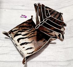 two decorative pillows made to look like zebras