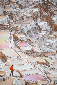 a man standing on top of a snow covered mountain