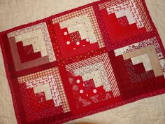 a close up of a red and white quilt