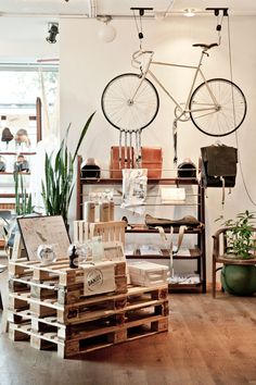 a room filled with lots of different types of furniture and decor on top of wooden pallets