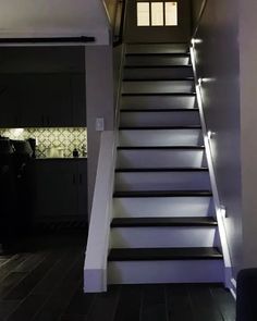 the stairs are lit up with leds in this home's entryway area