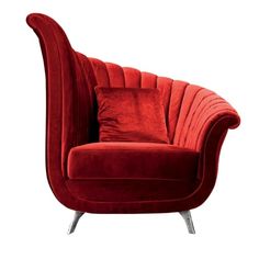 a red velvet chair with two pillows on it's back and the seat upholstered