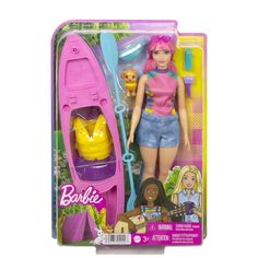 barbie doll with pink hair and blue shorts holding a purple toothbrush in her hand