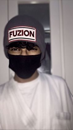 a man wearing a black and white hat with the word fuzio on it