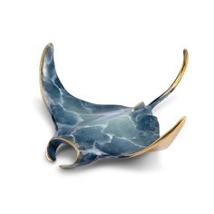 a blue and gold brooch with an animal's tail sticking out of it