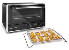 a toaster oven and tray filled with food