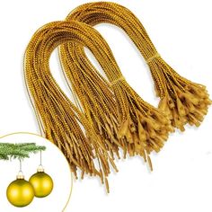 two yellow ornaments hanging from a string with a pine tree in the background and an ornament