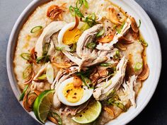 a bowl filled with rice topped with chicken and hard boiled eggs