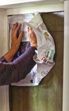 an older woman reading a newspaper on the wall